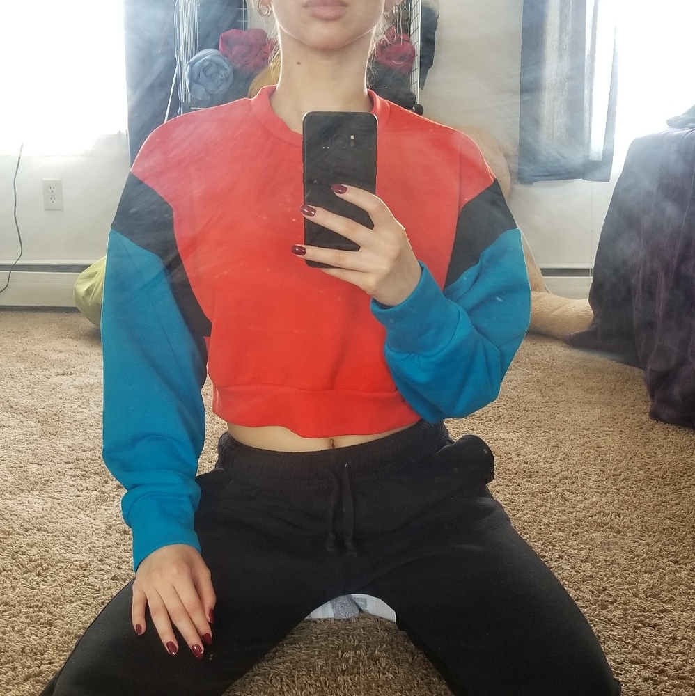 An NCLAGEN Orange, Blue, and Black Crop Top